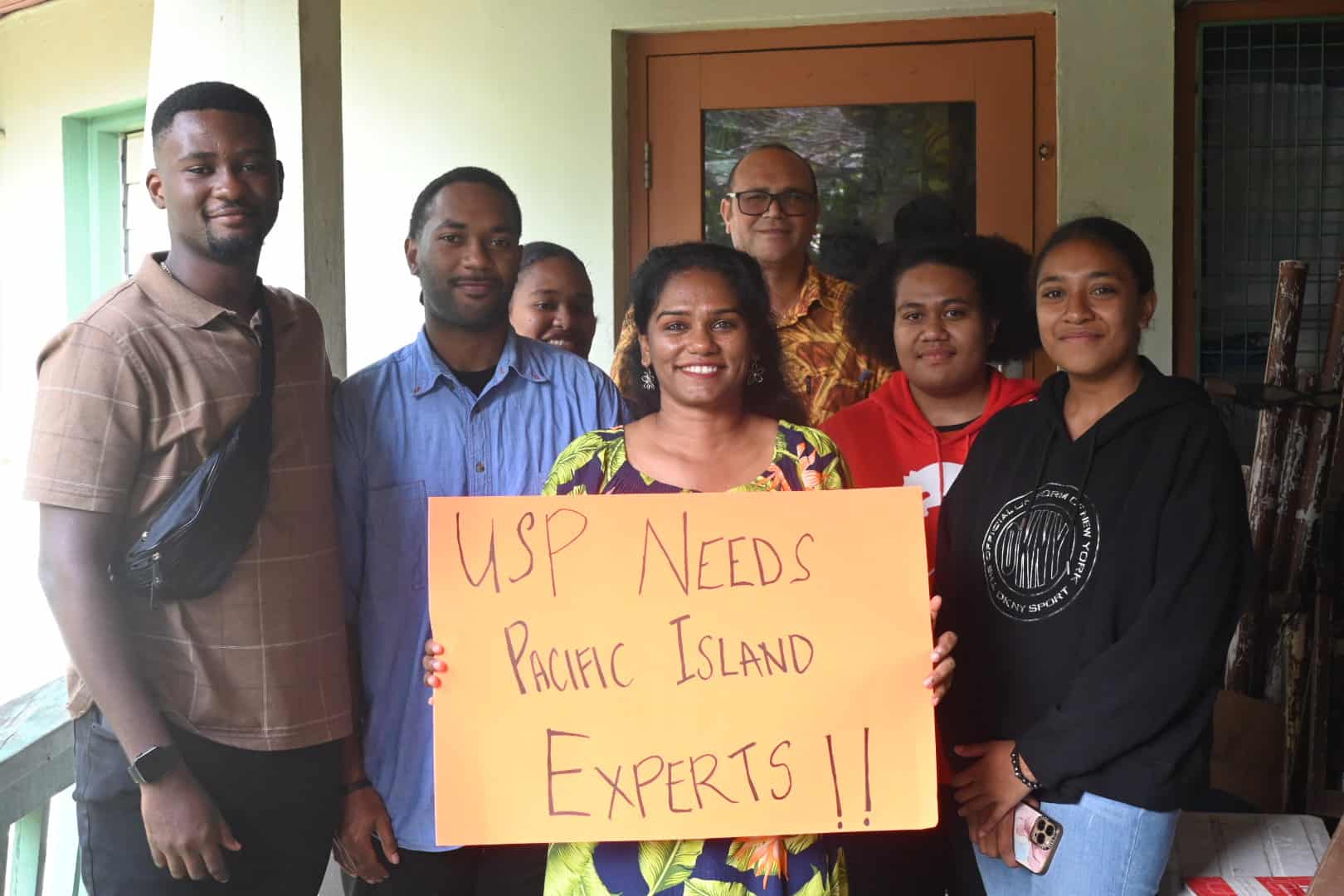 A group of students hold up a sign in support of Dr Osborne during the voting process.